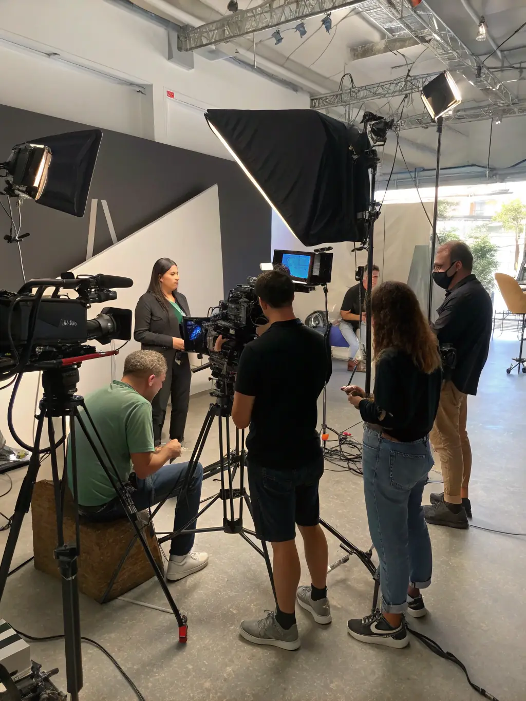 A behind-the-scenes shot of a corporate video production, highlighting the professional equipment and skilled team involved in creating high-quality content.