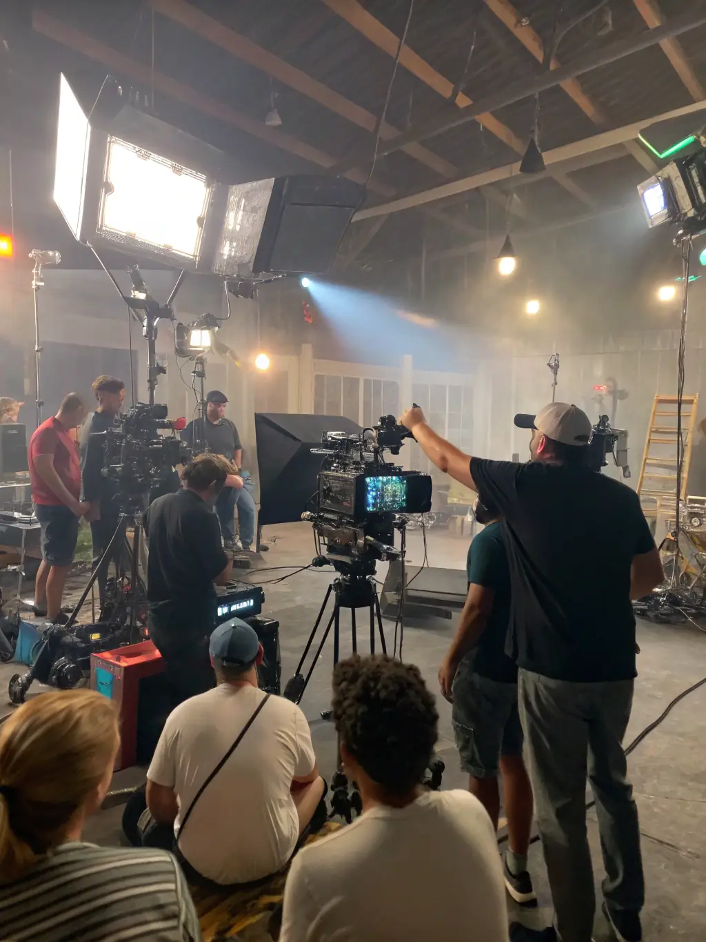 A professional film crew shooting a commercial in a modern office setting, showcasing the dynamic and engaging content OVEXA SOLS LIMITED can produce for businesses.